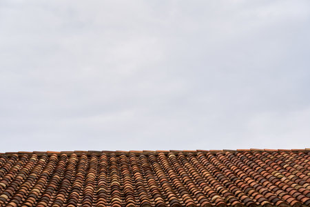 An old tiled roof against the sky as a background.の写真素材