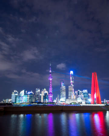 Shanghai, China - 06/11/2019: Shanghai skyline with light show for the international import and export expo ciie 2019 with bright skyline in the financial center of shanghai with river in the foreground. colorfulのeditorial素材