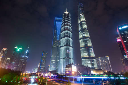 Shanghai Financial District at night. In foreground Jin Mao Tower, Shanghai World Financial Center...