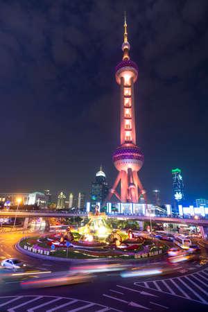 Oriental Pearl Tower in Shanghai at night with roundabout in the foregroundのeditorial素材