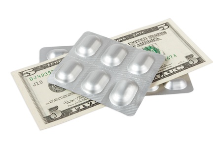 Pills and dollar isolated on whiteの写真素材
