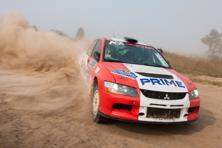 Ukraine. Kiev - August 15, 2010. The 5-th stage of the championship of Ukraine "Alexandrov Rally":  Driver Petrenko Y. and co-driver Eremenko D. drives their Mitsubishi EVO 9. The race in difficult conditions, very hot and dusty.のeditorial素材
