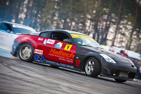 KIEV, Ukraine - April 24, 2010. The final stage of Ukrainian Championship Drift D1UDF. The driver Grinya (UKR) of black Nissan 350z drifting on the track. Autodrome Chaika in Kiev.のeditorial素材