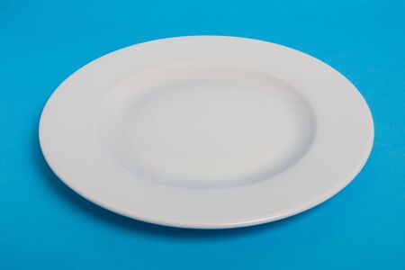 White empty plate on blue backgroundの写真素材