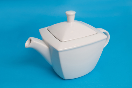 White kettle on blue backgroundの写真素材