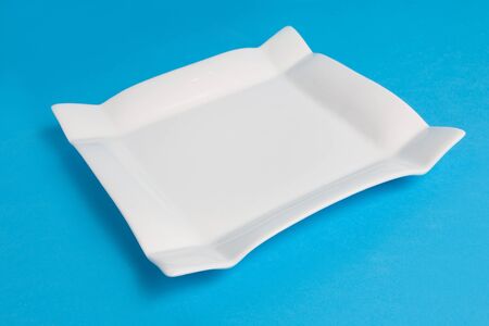White empty plate on blue background