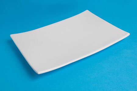 White empty plate on blue backgroundの写真素材