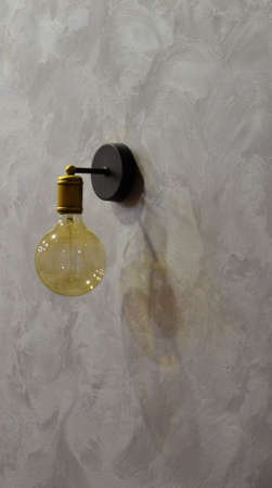 Pub pub, a long table with a chair and a lamp on it. Old brick wall. The end of the working day.の写真素材
