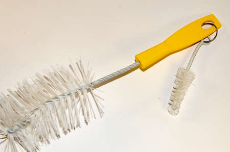 Brushes for dishes on the table with a yellow handleの写真素材