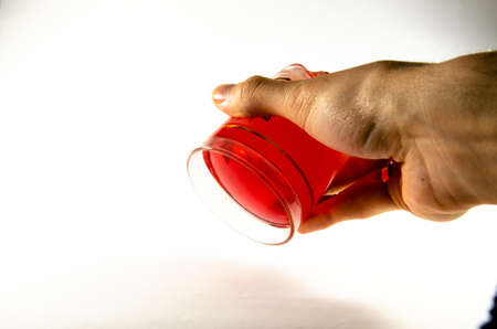 Bright red jelly in a glass on a light and dark backgroundの写真素材