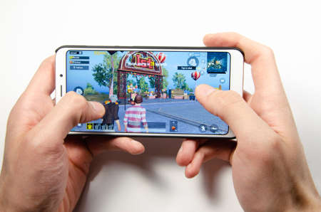 April, 2019. Kramatorsk, Ukraine. The gameplay of the game PUBG G Mobile on a white smartphone in handのeditorial素材