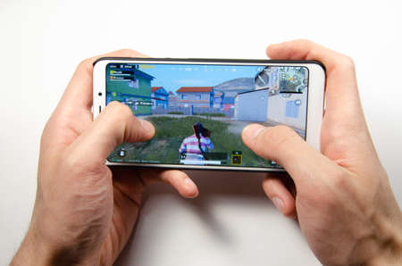 April, 2019. Kramatorsk, Ukraine. The gameplay of the game PUBG G Mobile on a white smartphone in handのeditorial素材