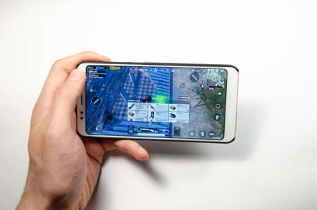 April, 2019. Kramatorsk, Ukraine. The gameplay of the game PUBG G Mobile on a white smartphone in handのeditorial素材