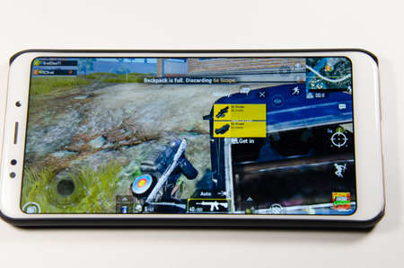 April, 2019. Kramatorsk, Ukraine. The gameplay of the game PUBG G Mobile on a white smartphone in...