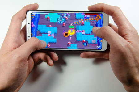 April, 2019. Kramatorsk, Ukraine. Brawl Stars gameplay on a white smartphone in handsのeditorial素材