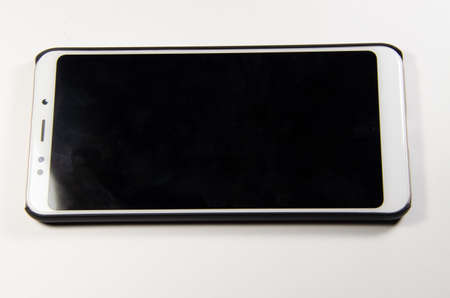 White smartphone with a black screen on a white backgroundのeditorial素材