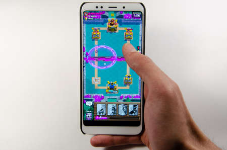April, 2019. Kramatorsk, Ukraine. Clash Royale gameplay on a white smartphone in handのeditorial素材