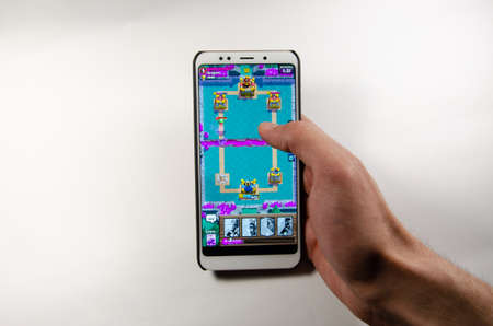 April, 2019. Kramatorsk, Ukraine. Clash Royale gameplay on a white smartphone in handのeditorial素材