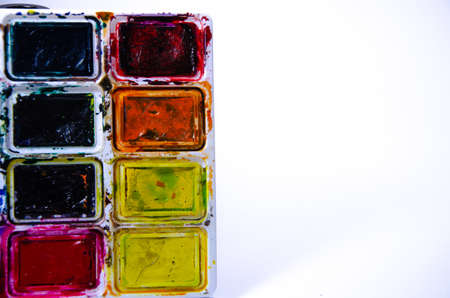 Palette with watercolors and brushes for paints on a white background. Watercolor paints. Brushes. Top and front viewの写真素材