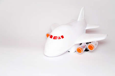 Airplane and dollars on a white background. Passenger airplane model on dollars and nearby. Business, air travel. Top and side view. Copy Spaceの写真素材