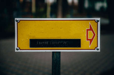 Yellow plate for your text with dots for reading by hands for the blind. Signpost sign for the blind and disabled. Signpost sign in the park for your text. CopySpace Copy Spaceの写真素材