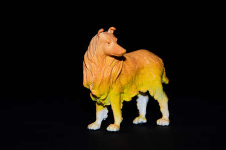 Plastic toy dog on a black background. Realistic toy  Copy Spaceの写真素材