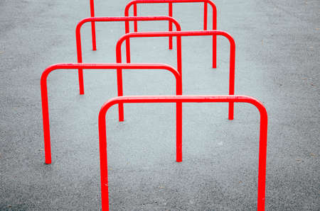 Red sports equipment stick out of the ground in a checkerboard pattern for snake running aroundの写真素材