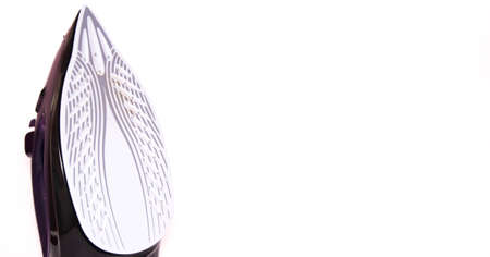 The iron is upright. modern with steam, steam boost, ceramic teflon sole on a white background. Macroの写真素材