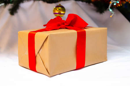 Boxes with gifts on a light, blue background and under the Christmas tree. Gift in the hand. Christmas presents, Nicholas Day, Valentine's Day. Bright boxes with bright ribbons. Gifts in Macroの写真素材