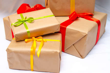 Boxes with gifts on a light, blue background and under the Christmas tree. Gift in the hand....