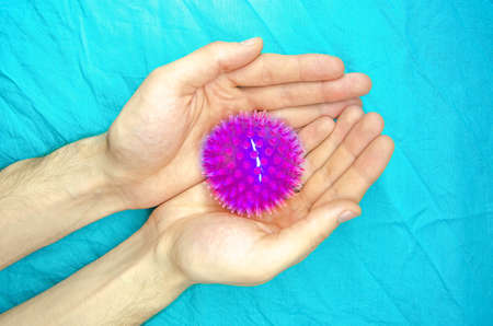 Chinese virus coronavirus, molecule. The texture of the virus in the hands and in medical gloves on a blue background. Epidemic, Disaster. Virus under the microscope, Coronavirus structure. CopySpaceの写真素材