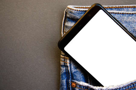 White screen smartphone in jeans pocket. Smartphone place for text. Smartphone in a pocket on a black background. Copy Spaceの素材 [FY310148162994]