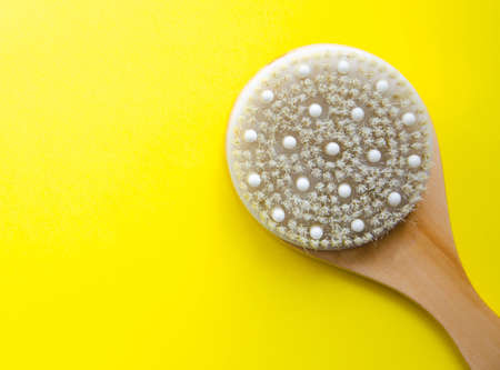 Dry massage. Brush made of natural cactus bristles, animals. Massage brush on a yellow background...