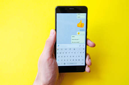 A male hand holds a smartphone, points a finger, types. Communication on a smartphone,...