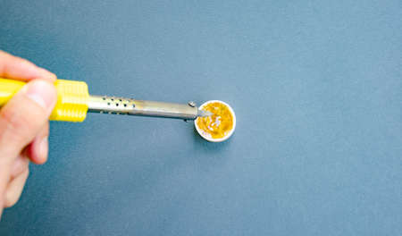  black Soldering iron, tin, rosin on a yellow background. Macro. Repair of electrical equipment, radio engineering. Solder wires, contacts. Copy Spaceの写真素材