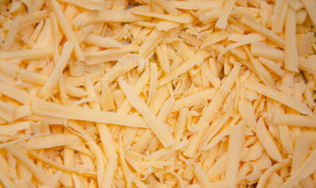 Grated hard cheese for homemade pizza. Russian, Dutch cheese. Grated cheese in macroの写真素材