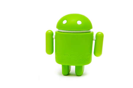 Android figurine. Green android figurine made of ecological plastic on a white background in macroのeditorial素材