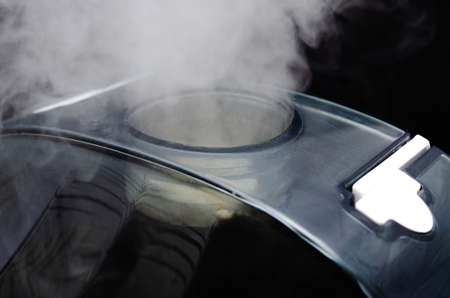 Humidifier on a black background. Humidifier overall plan and macro. The device is face and sideways. Steam water in macro. Black navigation bar, humidifier controls white touch mode keys. Mine, steam compartment, entrainment, processの写真素材
