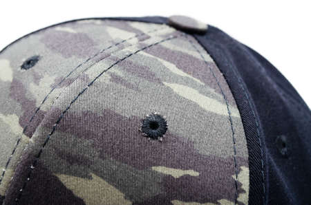 Men's two-tone cap on a white background. The baseball cap is black at the back, front and visor of the military workshop, khaki camouflage. Men's black cap with camouflage in macro. Side view, stern, top. Cap closure, button on top, ventilation holeの写真素材