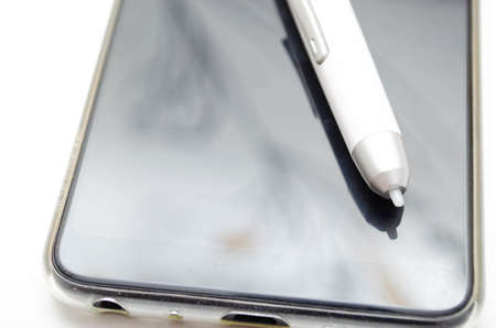 Electronic signature on a white background. Stylus pen for signing on a smartphone, display in a...
