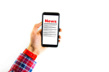 News. Reading the news. The inscription red news on the smartphone screen lies on a white background. Male hand holds a smartphone, clicks, leafs through the newsの写真素材