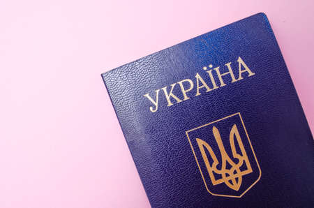 Ukrainian passport on a pink background. The passport of the citizen of Ukraine in the macro. Passport general plan and close-upの写真素材