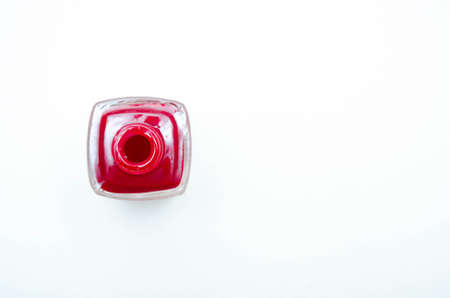 Nail polish. Bottle, tube, bottle with red nail polish, burgundy color. A bubble without a cap is on the left, place for text is top viewの写真素材