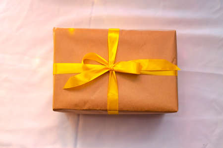 Boxes with gifts on a light, blue background and under the Christmas tree. Gift in the hand....