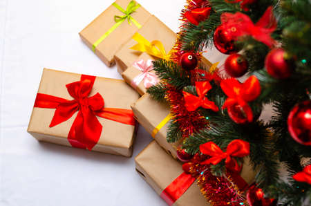 Boxes with gifts on a light, blue background and under the Christmas tree. Gift in the hand....