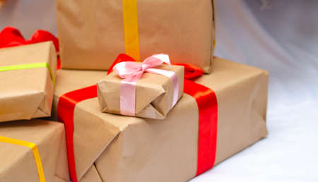 Boxes with gifts on a light, blue background and under the Christmas tree. Gift in the hand....