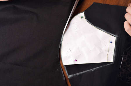 Making a medical black mask with your own hands at home. DIY protective mask. Black mask on a white...