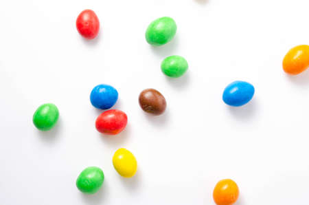 M & M's in packaging on a white background. Glazed nuts spilled out of the packaging on a white background cc close-up. M & M's on a white background balls top and bottom view. M & M's cutaway. July 2020. Kiev, Ukraineのeditorial素材