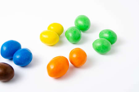 M & M's in packaging on a white background. Glazed nuts spilled out of the packaging on a white background cc close-up. M & M's on a white background balls top and bottom view. M & M's cutaway. July 2020. Kiev, Ukraineのeditorial素材
