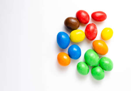 M & M's in packaging on a white background. Glazed nuts spilled out of the packaging on a white background cc close-up. M & M's on a white background balls top and bottom view. M & M's cutaway. July 2020. Kiev, Ukraineのeditorial素材